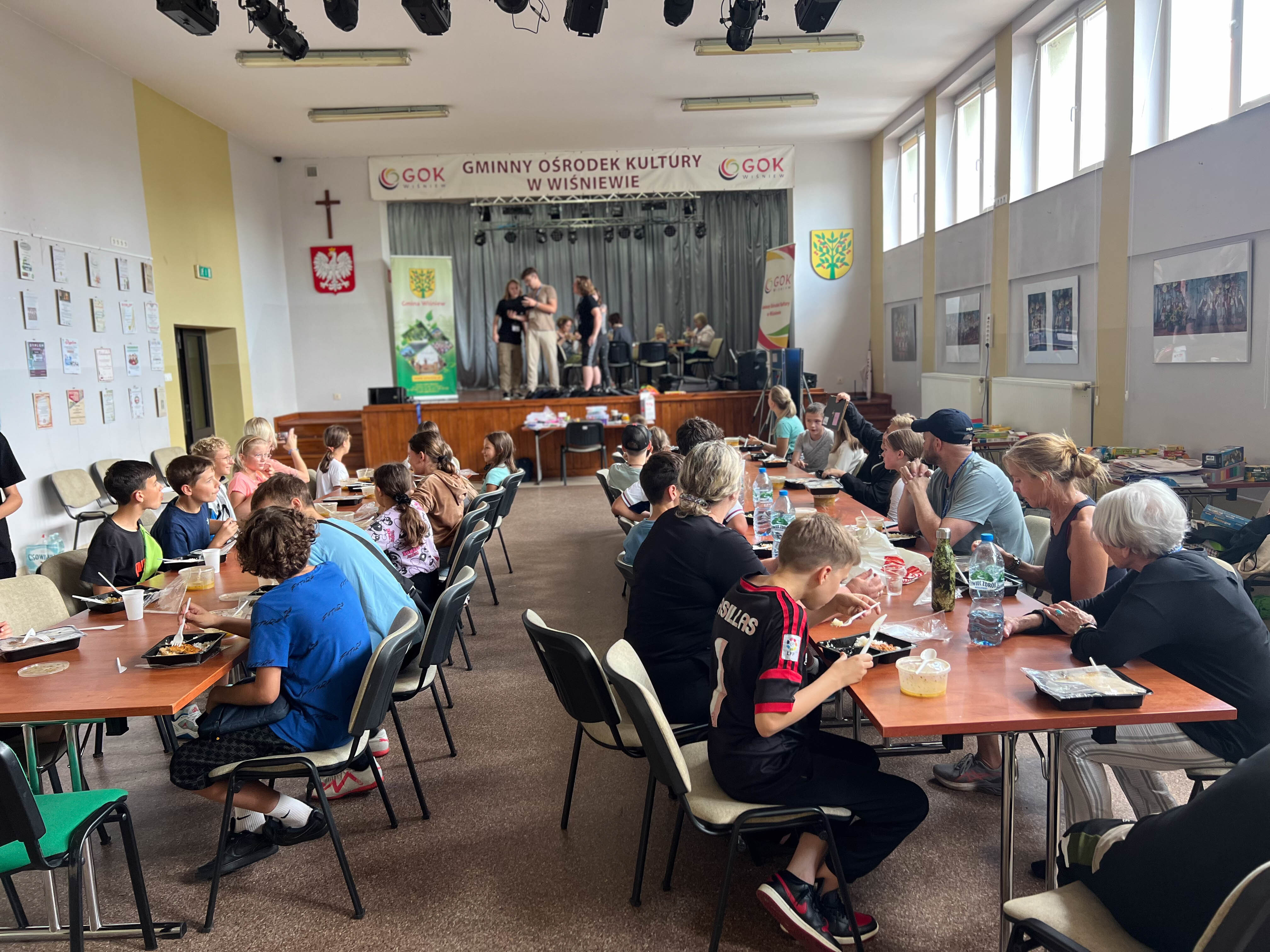 Kids eating lunch at Adam's summer camp for Ukrainian refugees in Poland.