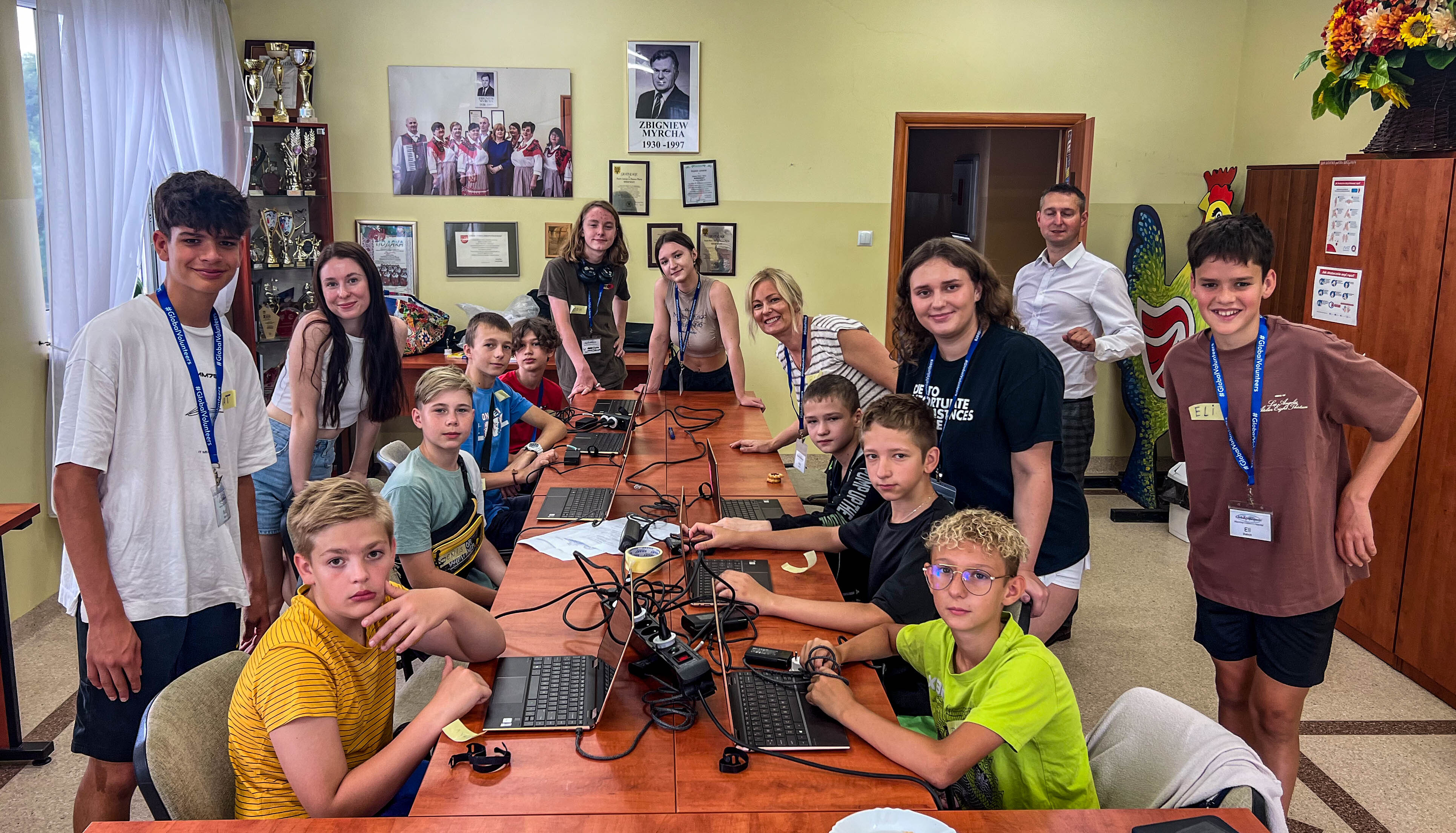 Volunteers helping children set up their new laptops.